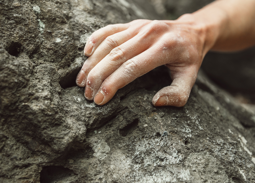 Close-up of climber hand on rock